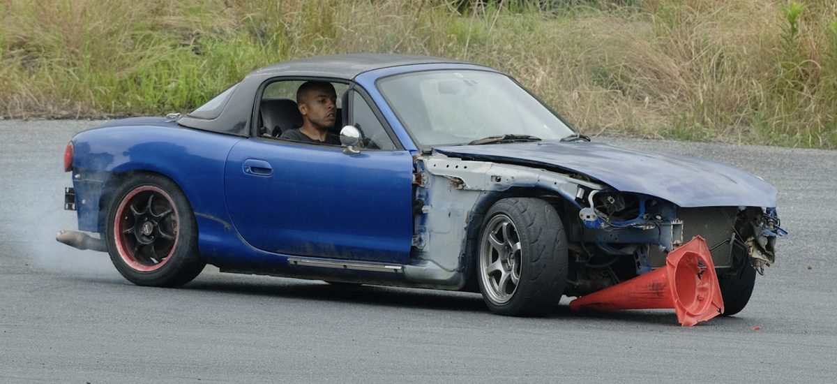 Lee drifting a blue Mazda Roadster at a drift school in Japan
